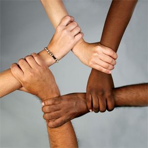 A group of people holding hands in a circle.