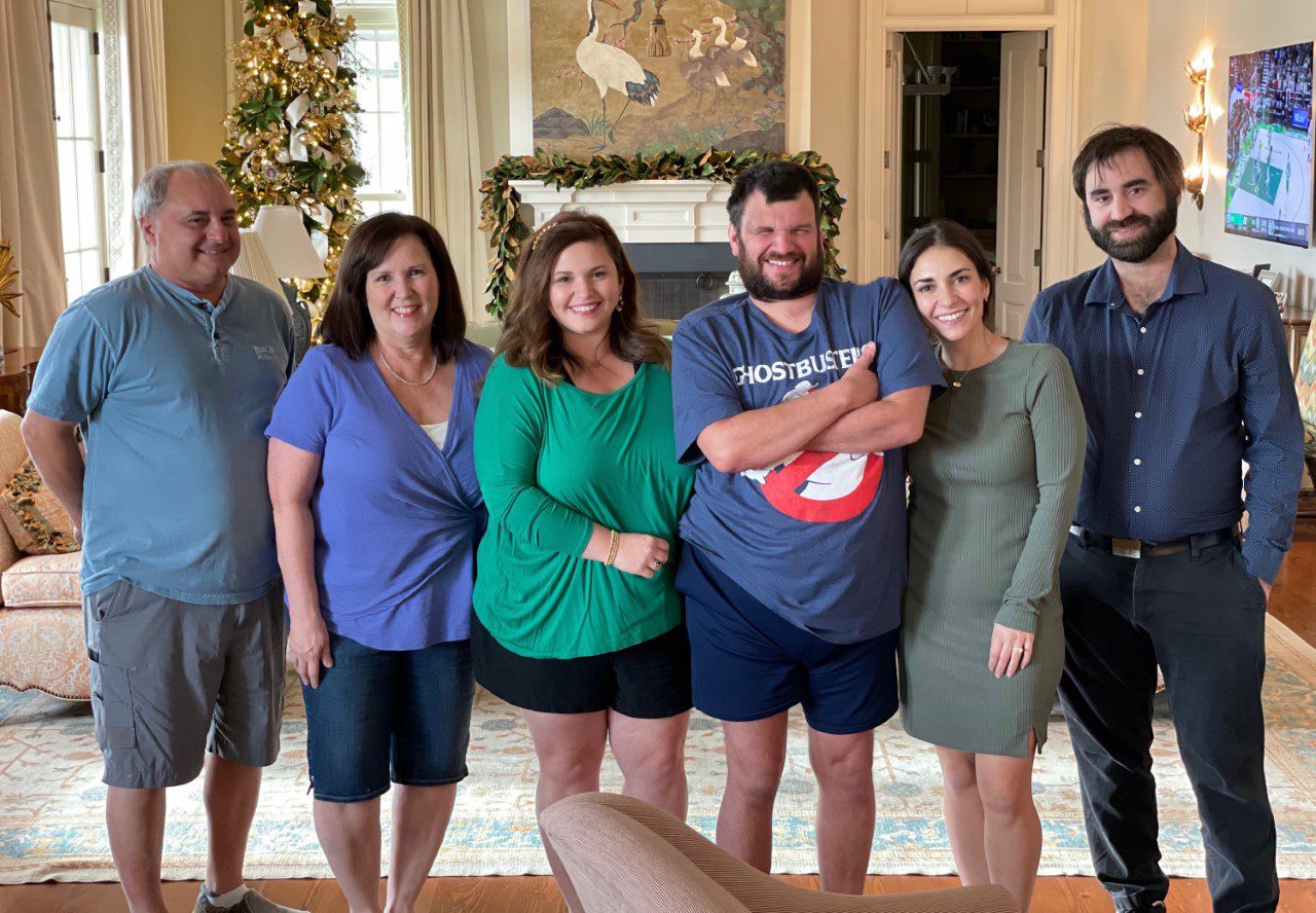 A group of people posing for a picture in a living room.