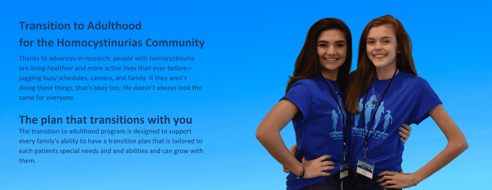 Two girls in blue shirts standing next to each other.