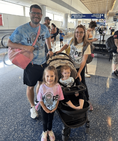 Family wearing Hope Connects Us shirts at airport.