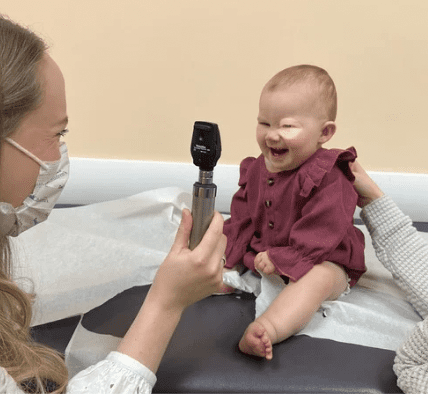 Child eye exam with ophthalmoscope