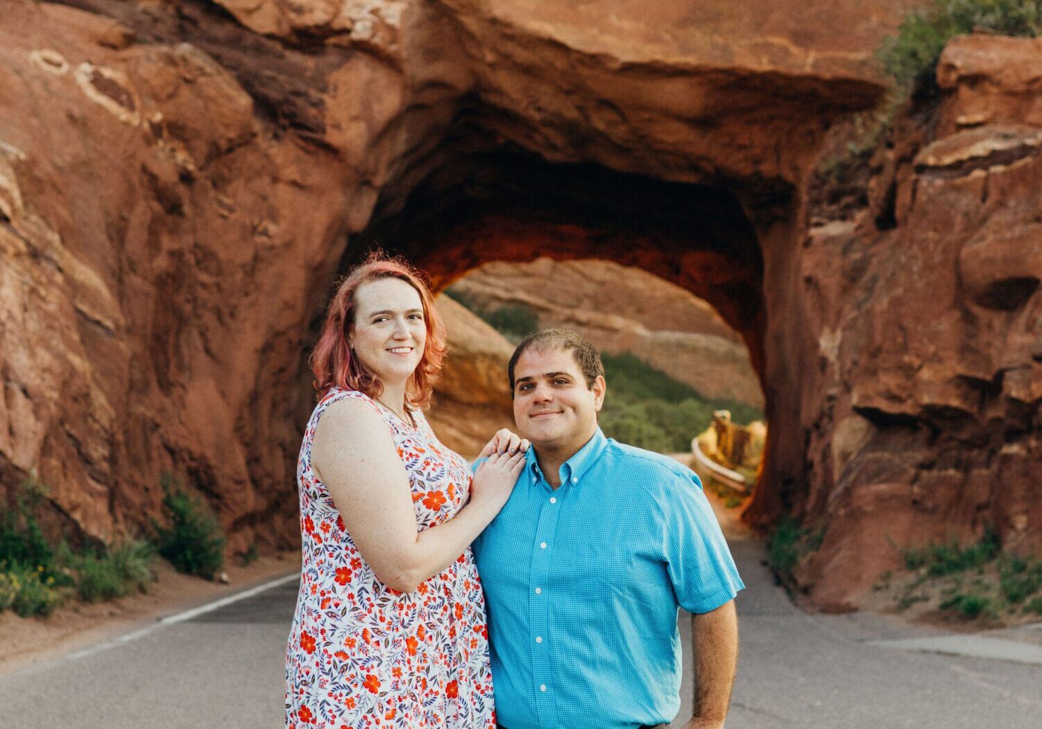 A man and woman standing in front of a tunnel.