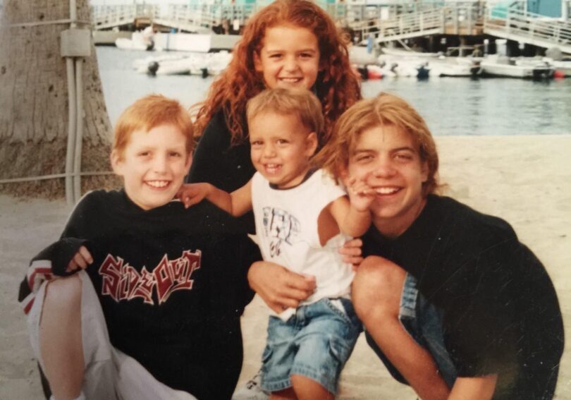 A family posing for a picture on the beach.