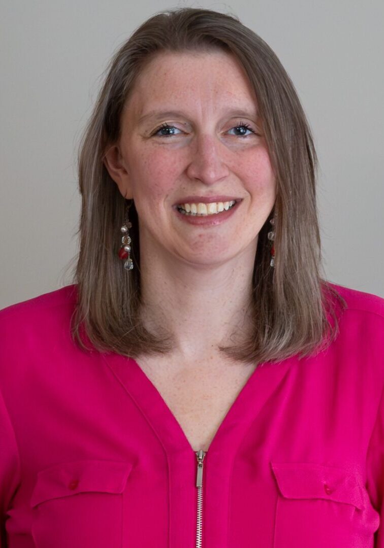 Smiling woman in pink shirt with zipper