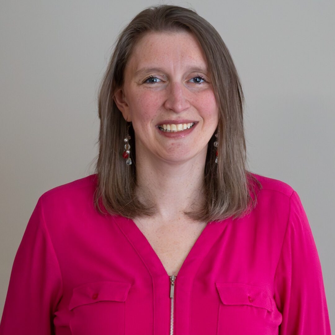 Smiling woman in pink shirt with zipper