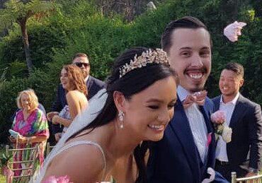 A bride and groom smiling as they walk down the aisle.