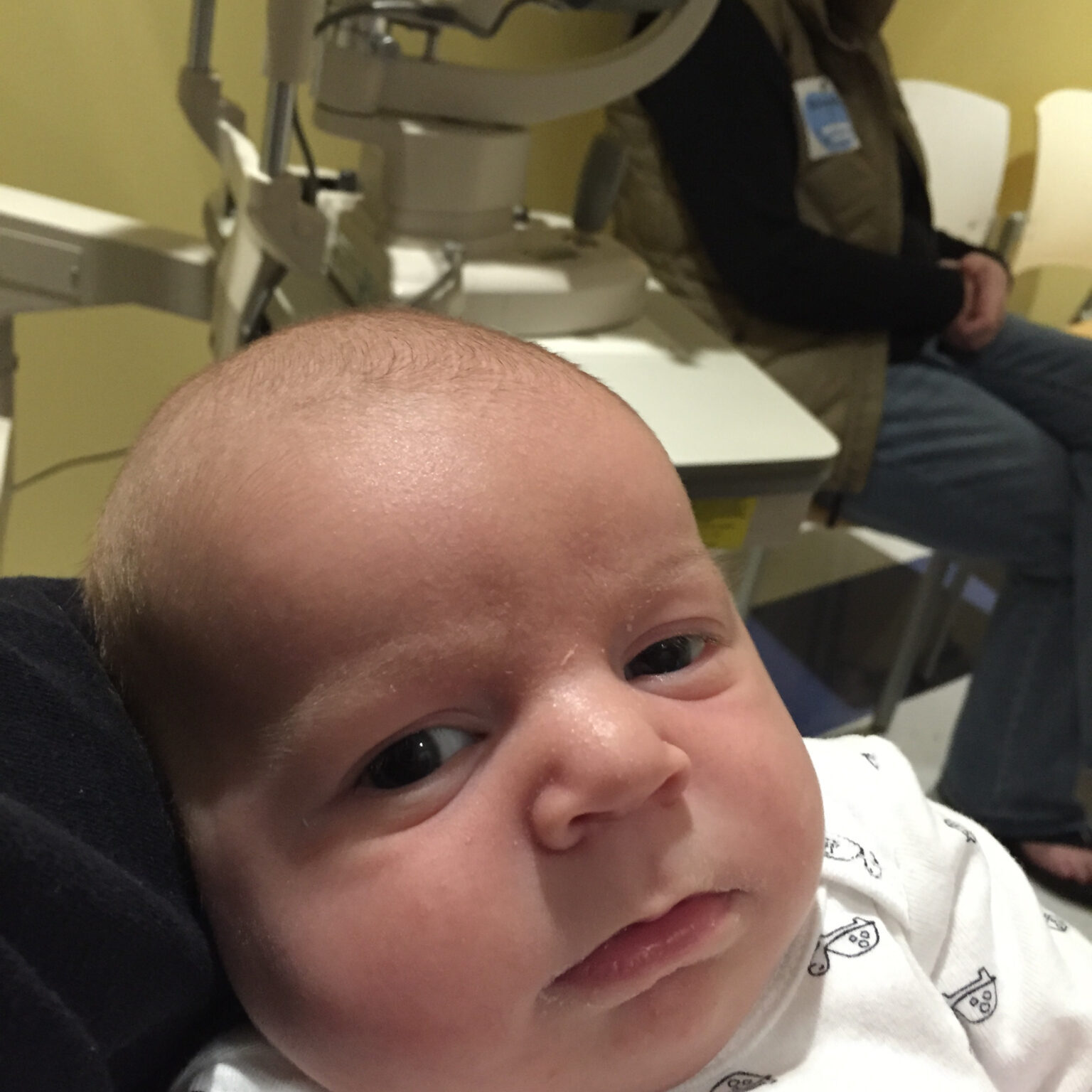 A baby is sitting in a doctor's office.