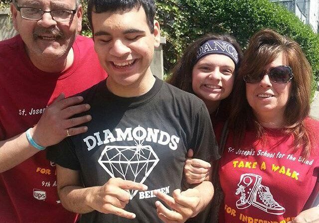 A group of people posing for a picture with a diamond ring.