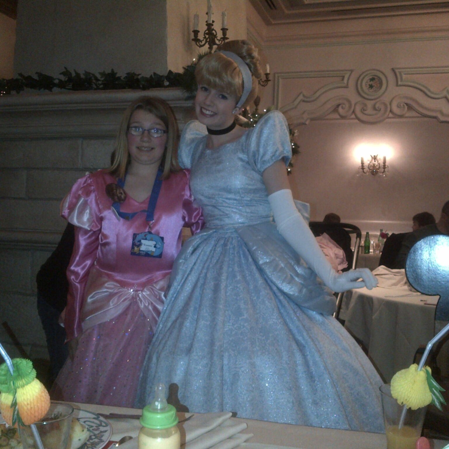 A woman in a cinderella dress posing for a picture.